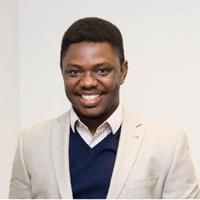 Godwin Aleku. Credit: Godwin Aleku Headshot of Godwin Aleku. Godwin is wearing a shirt and cream jacket.