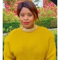 Pamela Sweeney. Credit: Pamela Sweeney Photo of Pamela Sweeney. Pamela is wearing a yellow jumper and is standing in a garden.