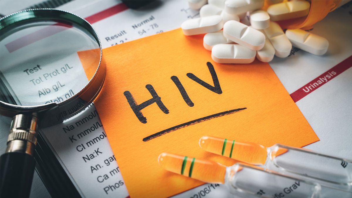 A note with the word "HIV" surrounded by drugs and a magnifying glass, representing HIV drug discovery.