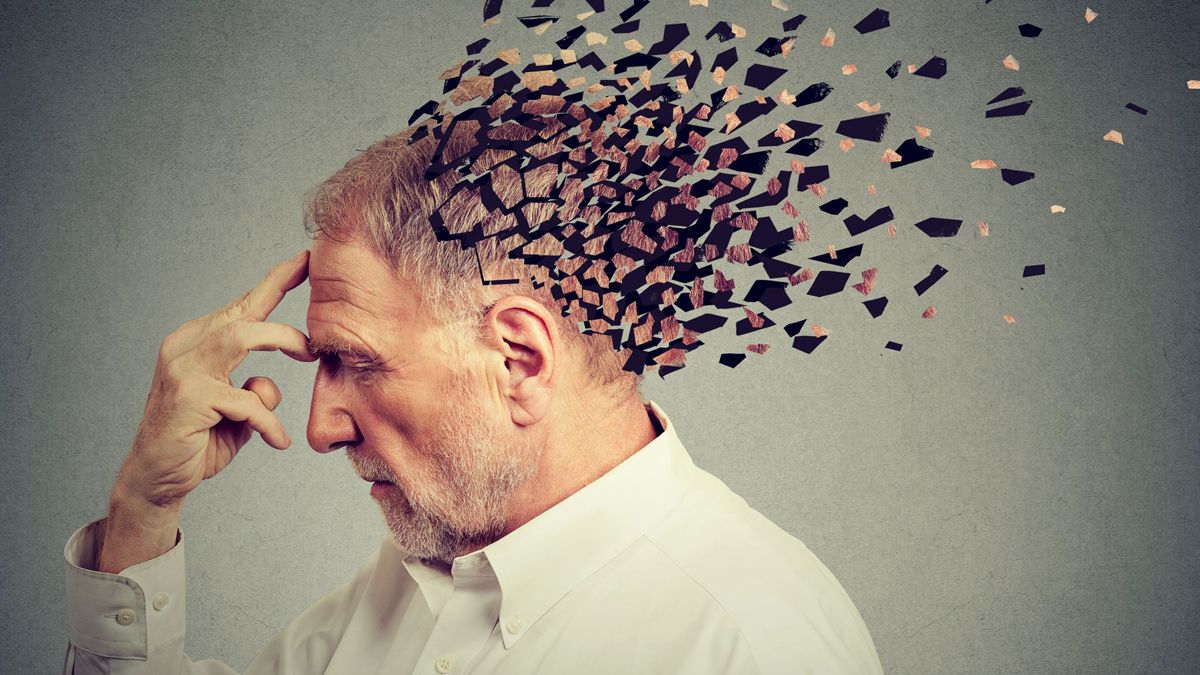 Elderly man with fragmented head symbolizing COVID-19-related memory loss and cognitive decline.
