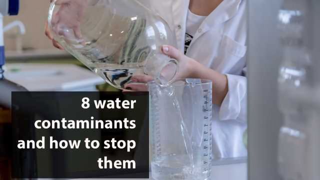 A scientist pours water from a large glass jar into a measuring cylinder. 