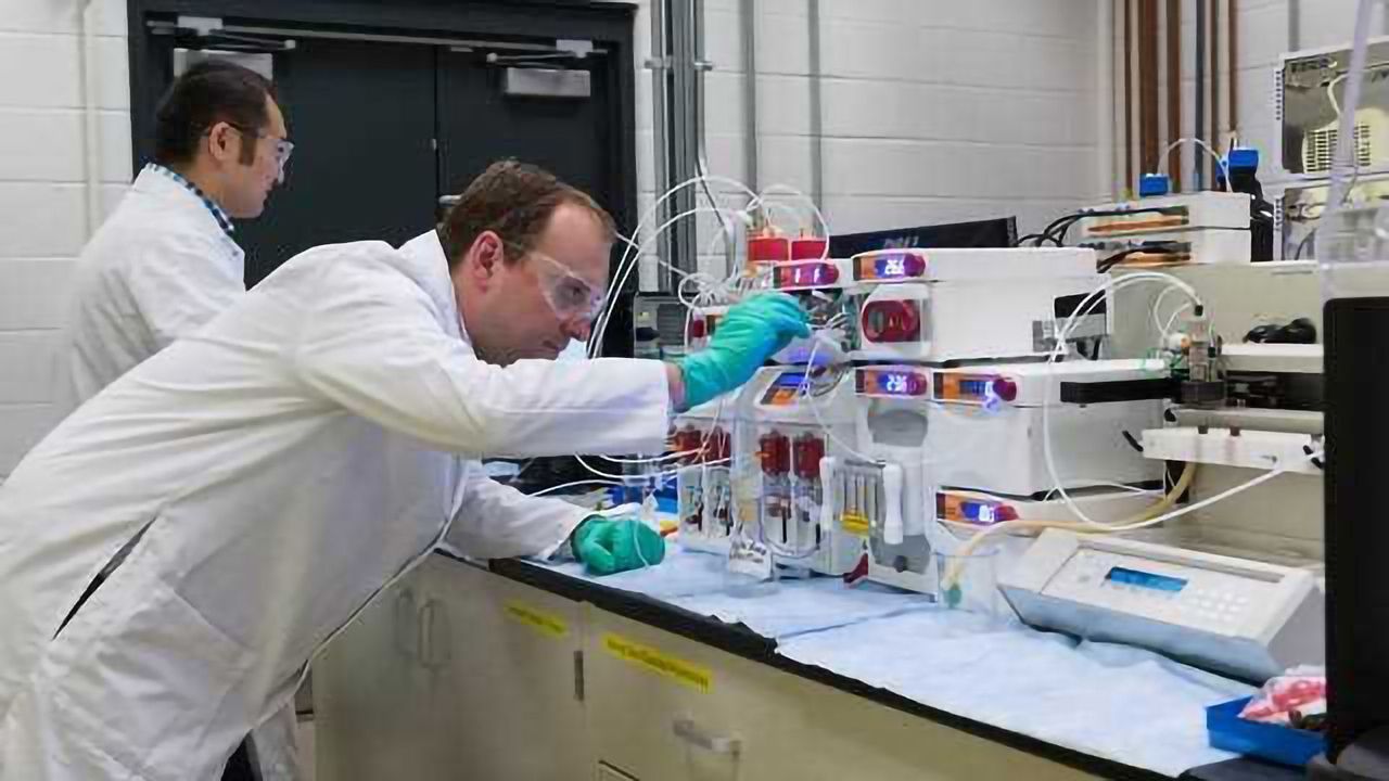 Adapting Continuous Flow Processing to Complex Nanomaterials to Reduce Manufacturing Costs