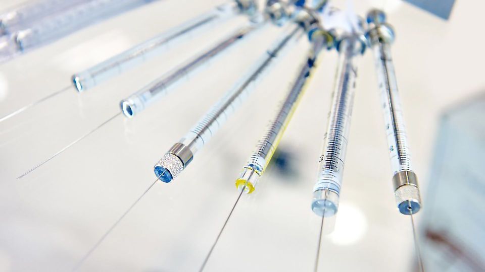 Gas chromatography injection needles pointing downwards.