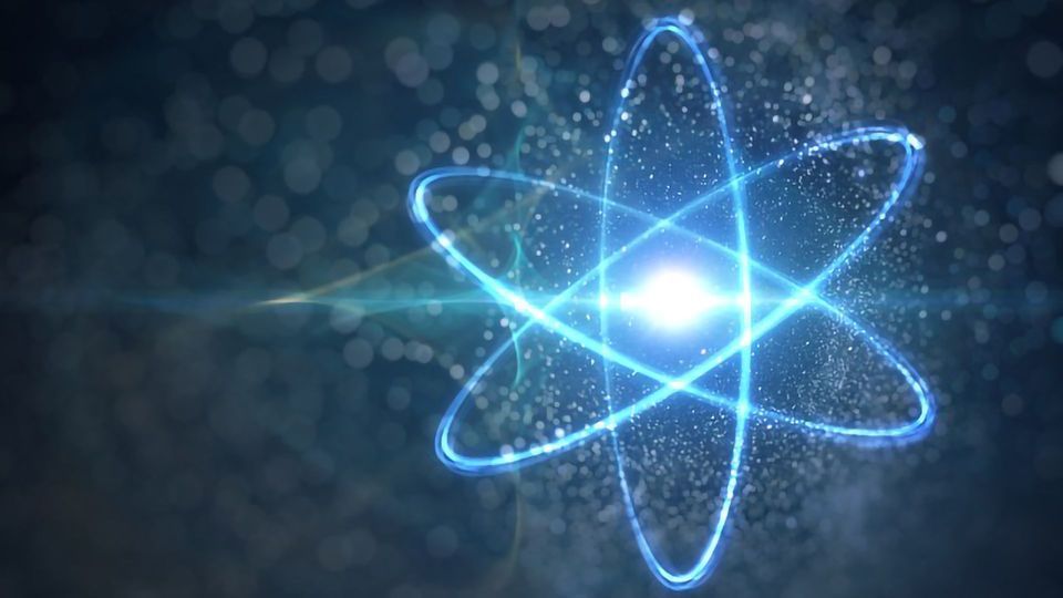 The movement of electrons around an atomic nucleus in bright blue.