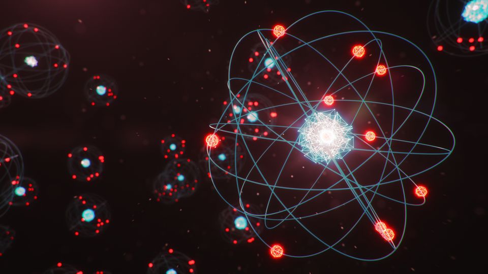 One larger atom, and several smaller atoms in the background.