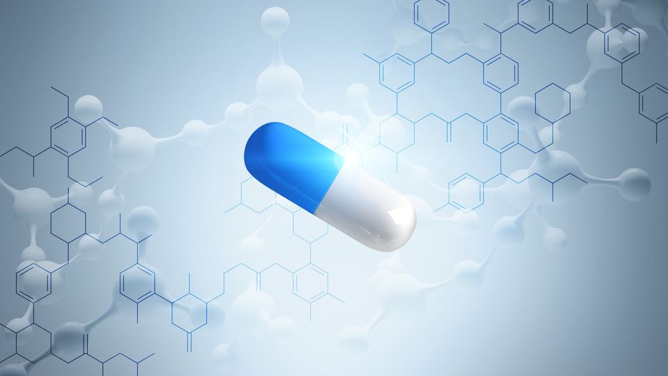 A blue and white pill with illustrations of chemical compounds behind.