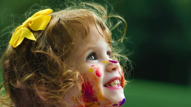 A girl covered in paint.
