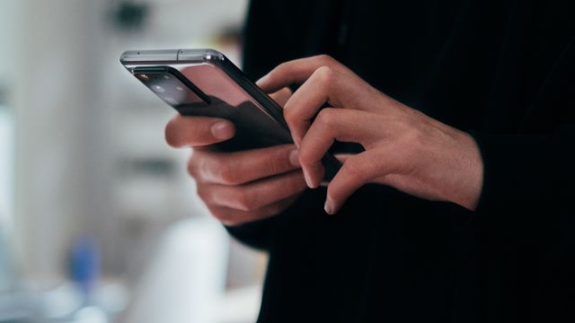 A person holding a smartphone.  