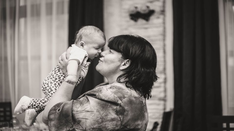 A woman holding a baby. 