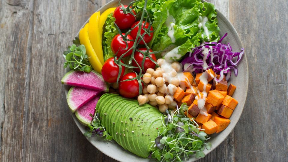 A bowl of salad, with several different vegetables.