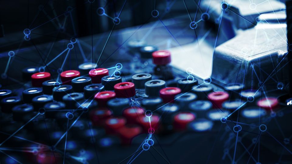 Vaccine vials overlaid with blue lines and circles to represent a data network.