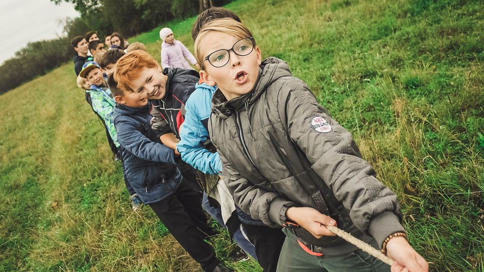 A group of children playing tug of war.