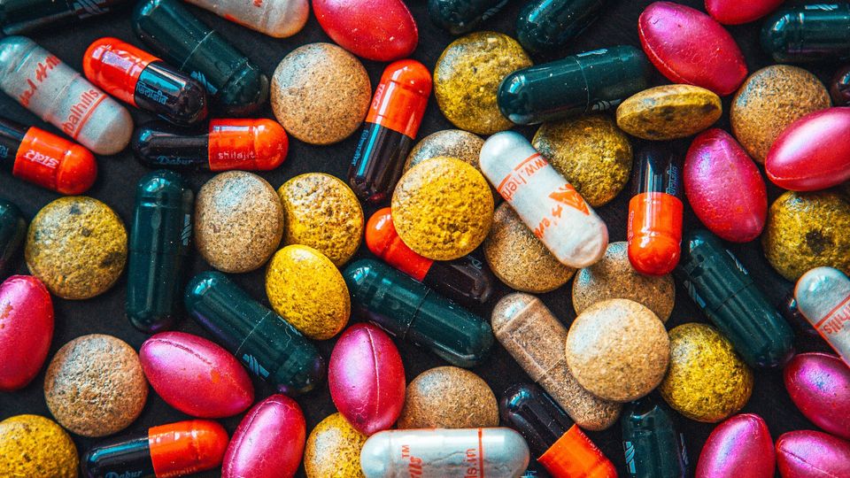 Tablets and pills of different shapes, sizes and colors.