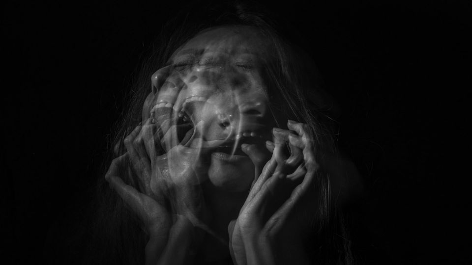 A blurred image of a person screaming.