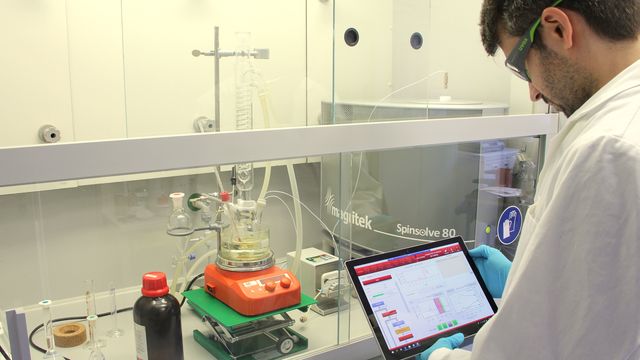 A scientist looking at an iPad in a laboratory.