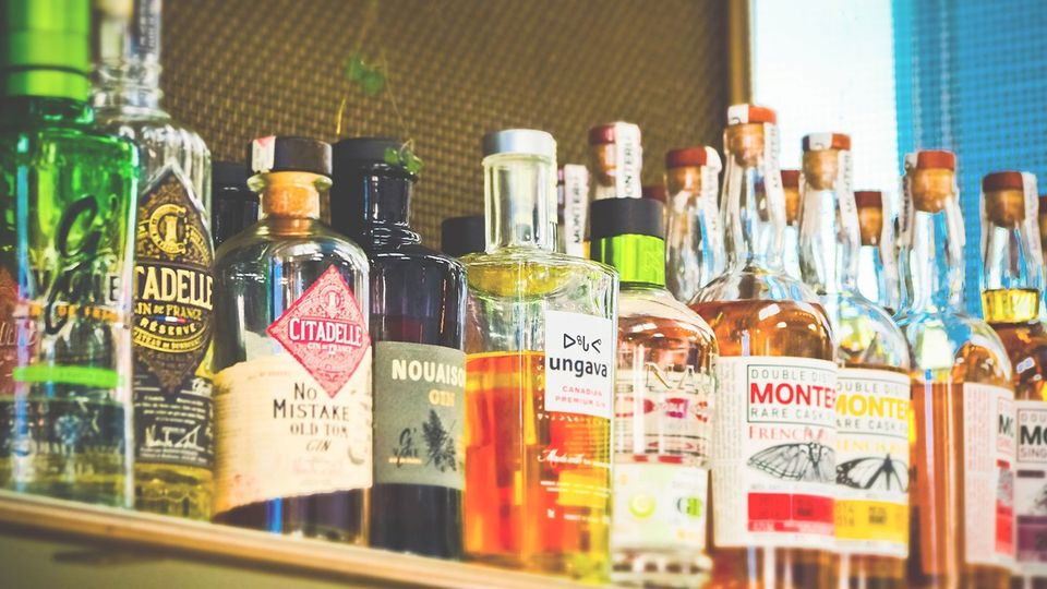 Bottles of alcohol on a shelf.