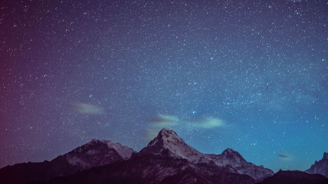 A starry sky above mountains. 