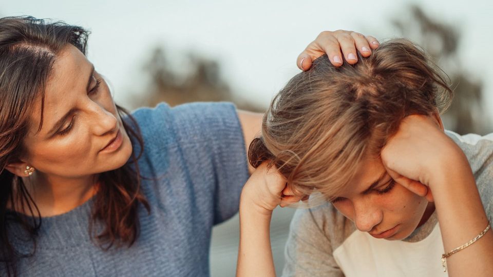 A mother comforts a child.