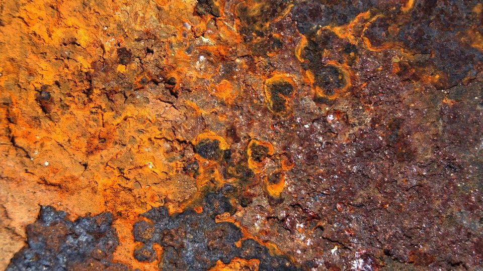 A surface with bright orange and dark brown rust.