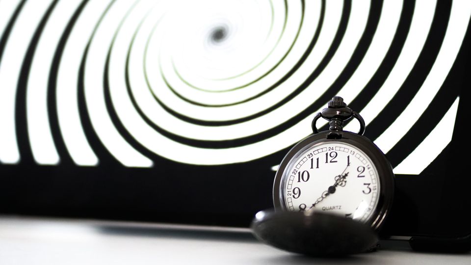 A black and white spiral with a clock.