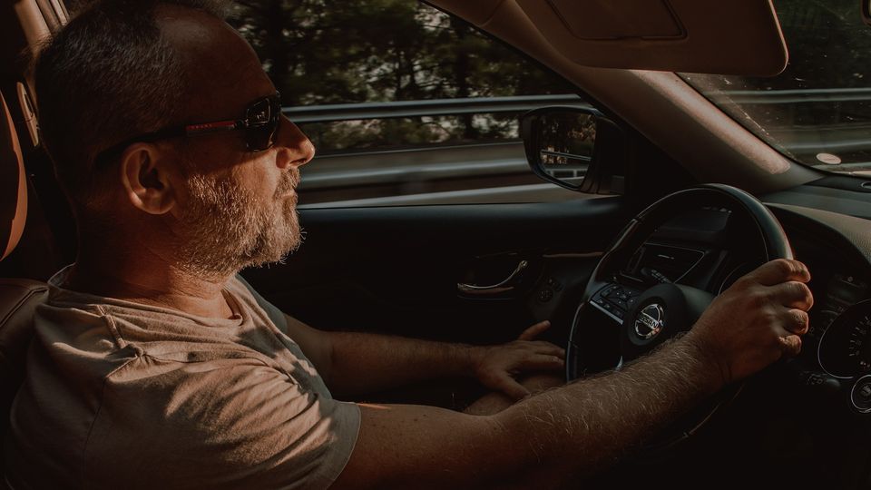 A man driving a car.
