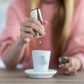 A mug and sweetener. 