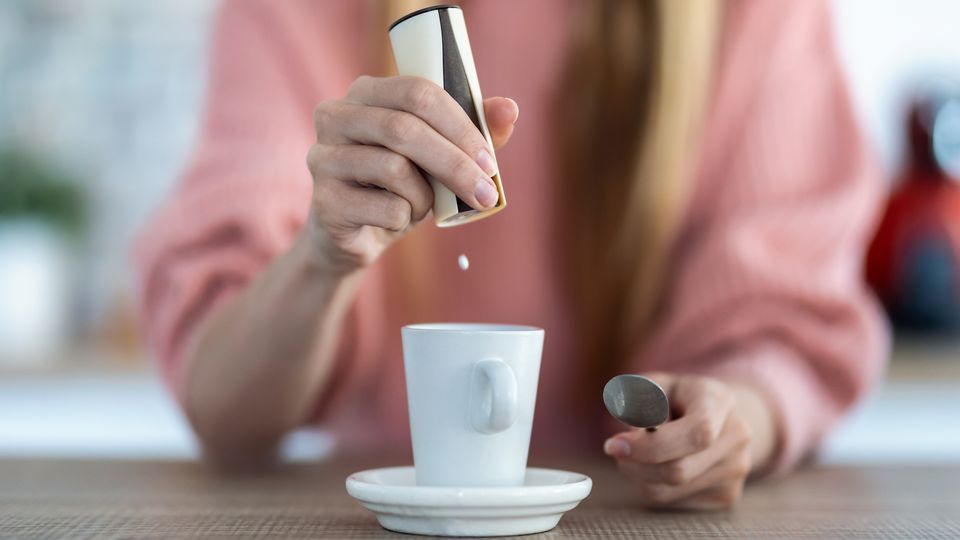 A mug and sweetener.