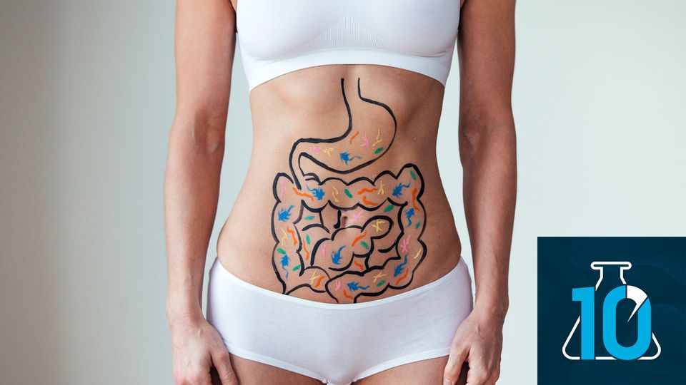 A person standing with a cartoon of an intestines with bacteria on their stomach.