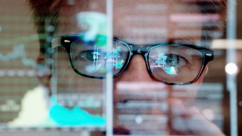 Scientist behind a screen.