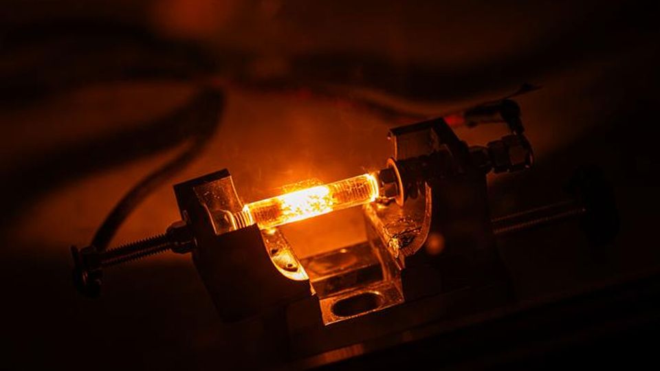 Two wires attached to a red-hot piece of material.