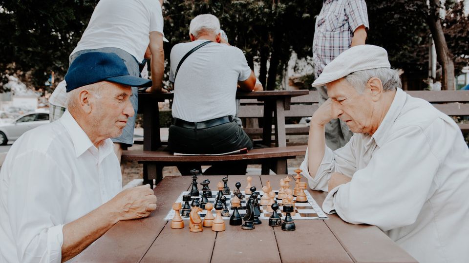 Two elderly men playing chess.
