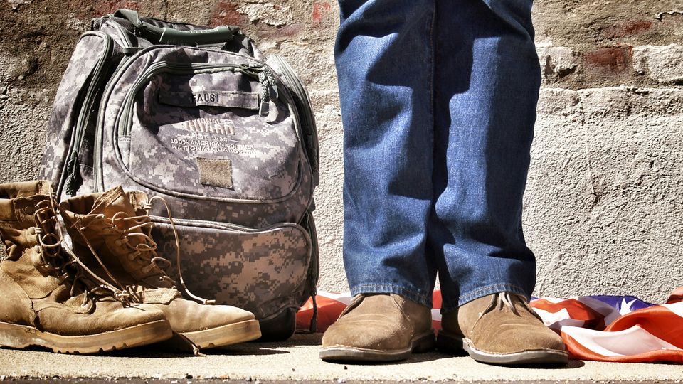 A person with military boots and a rucksack.