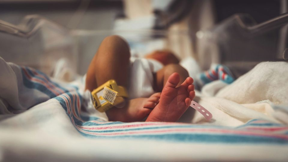 A baby in a hospital bed.