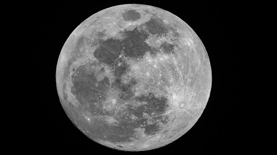 The moon surrounded by darkness.
