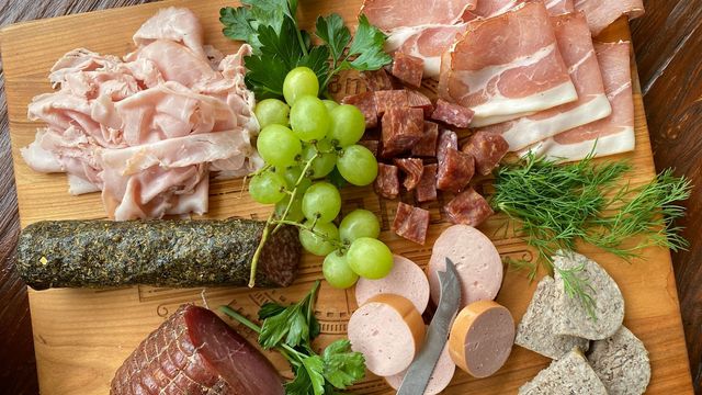 A charcuterie board filled with cold cuts. 