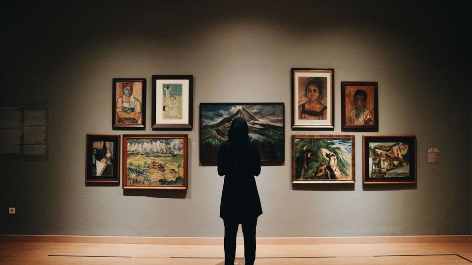 A person looks at art in a gallery.