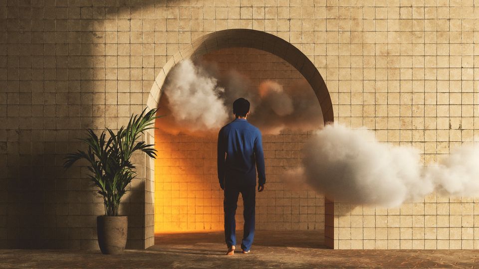 A man walking into an archway with clouds around him.