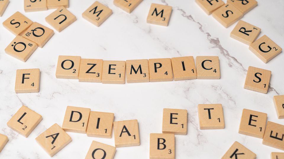 Scrabble tiles spelling out the word "Ozempic".