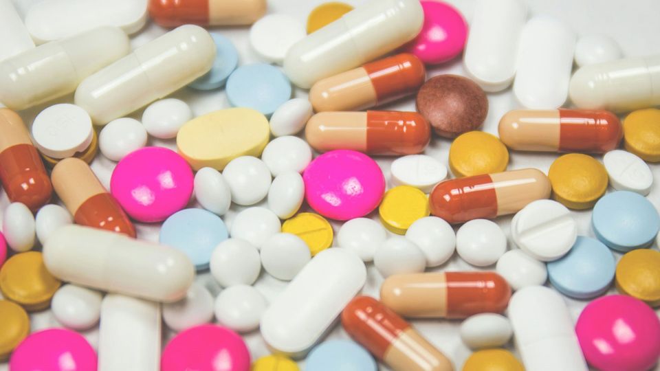 Drug capsules of different sizes, colors and shapes.
