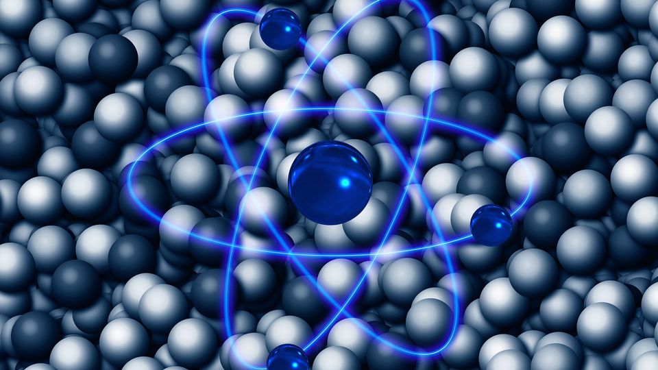 Atom symbol overlaid on grey spheres.
