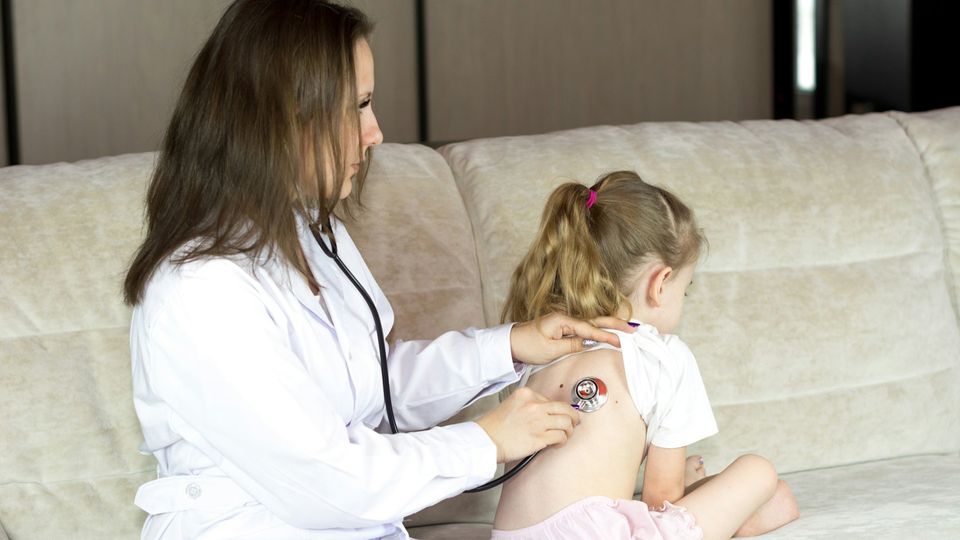 A doctor with a child.