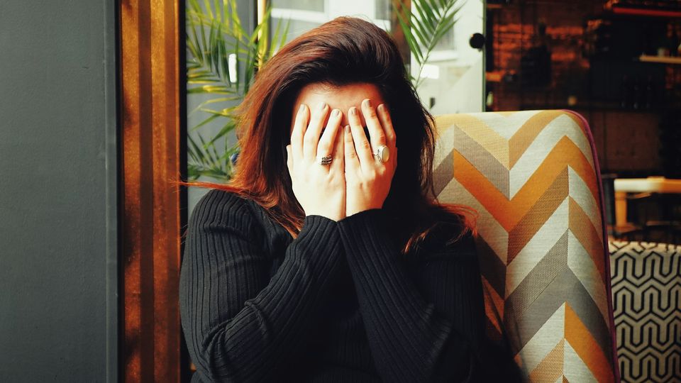 A person holding their head in pain.