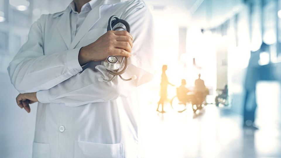 Doctor holding stethoscope in hospital