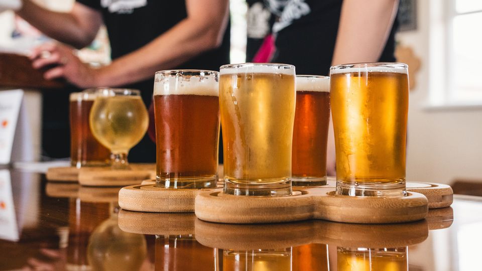 Glasses of beer on a table.