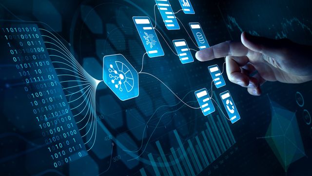Hand pointing towards a visual representation of data processing, analysis or artificial intelligence (AI) technologies, featuring elements like binary code, charts and data flow diagrams. 