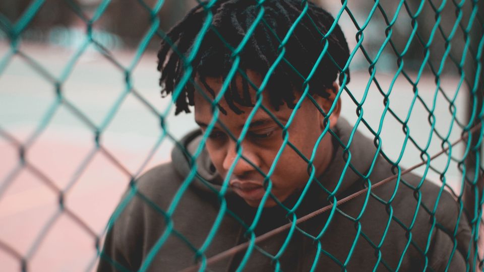 A black man that looks sad.