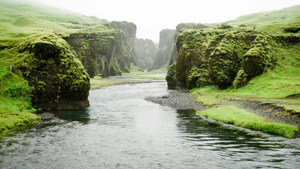 A river runs through green hills.