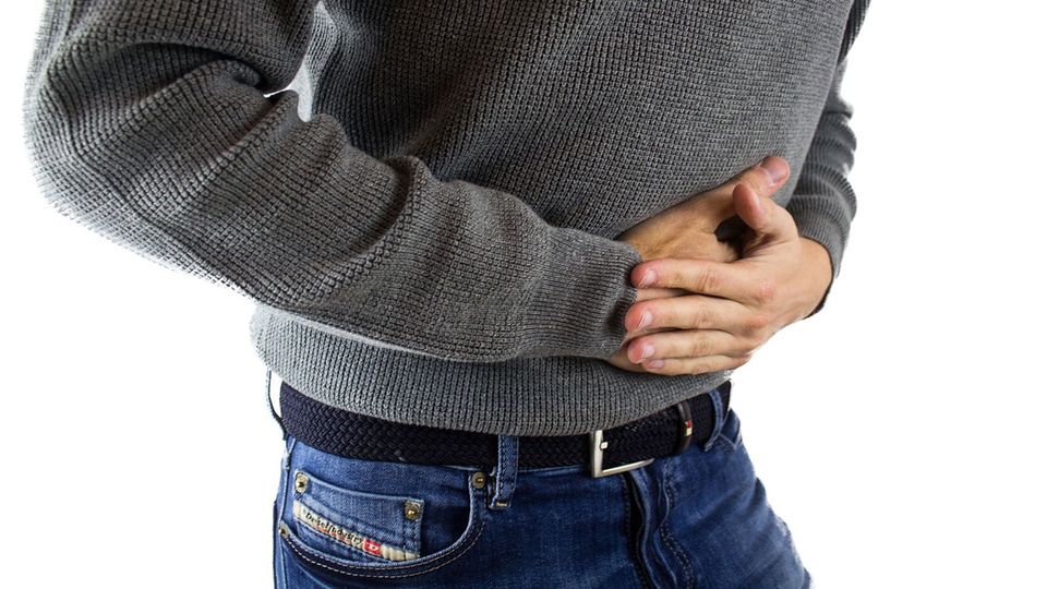 Man holding his stomach in pain.