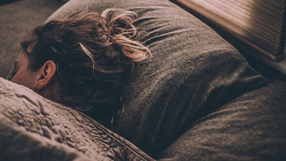A girl sleeping in bed.