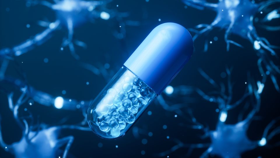 A blue pill on a background of nerve cells.